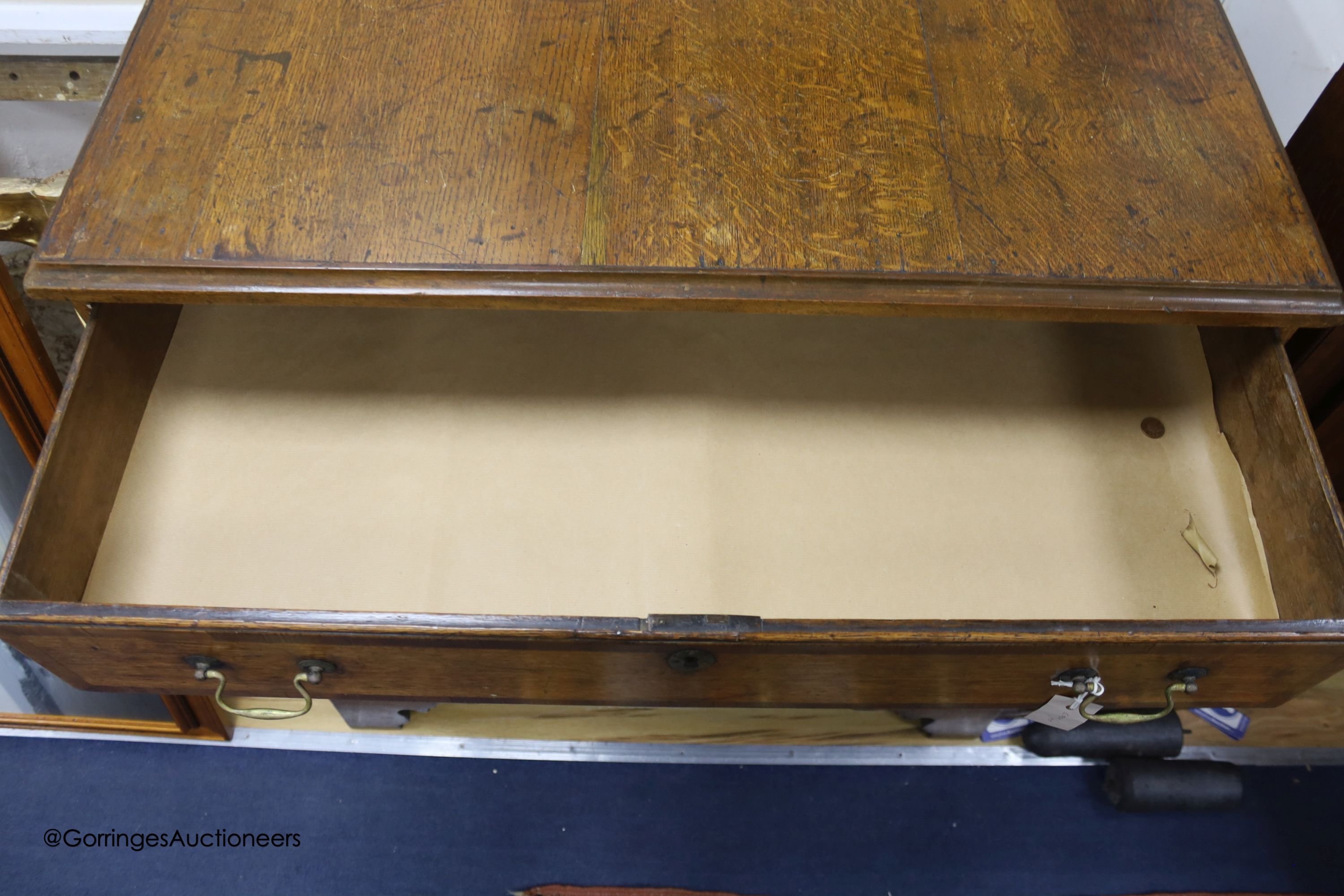 An 18th century oak chest of four graduated drawers